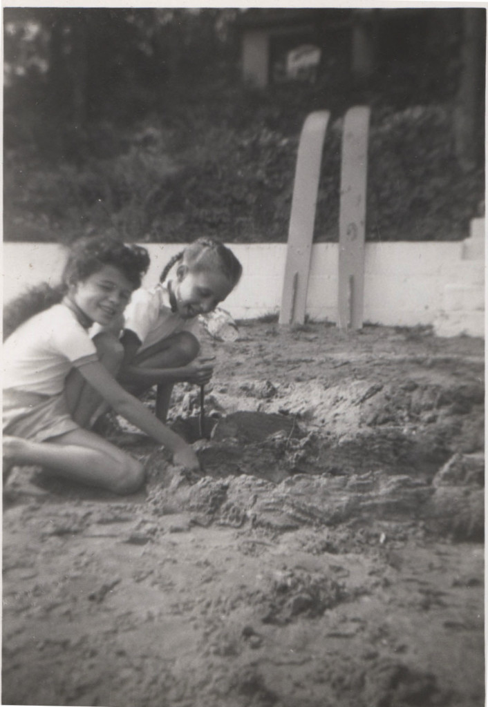 My cousin and me playing in the sand during the visit Louis chased her into the lake.